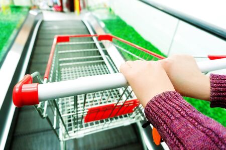 Lady pushing a shopping cart in the supermarket.の写真素材
