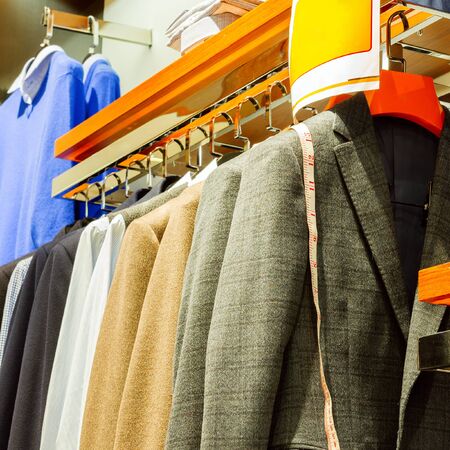 Row of men's suits hanging in closet.の写真素材