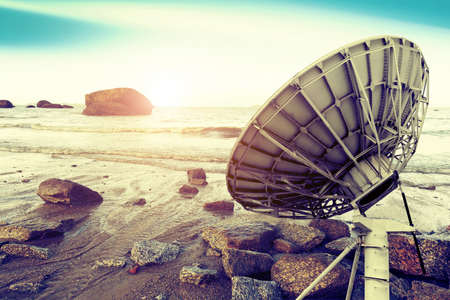 Satellite dishes at beautiful sunrise backgroundの写真素材