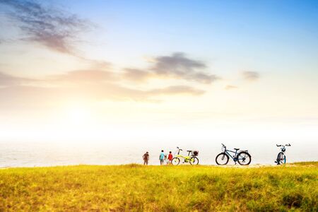 Teenager playing beside of the river, twilight landscape.の写真素材
