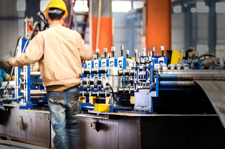Steel factory assembly line, workers in the next molding equipment.