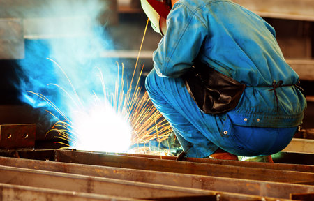 Workers at work, ongoing welding operation.