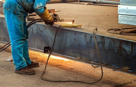 Workers at work, ongoing welding operation.