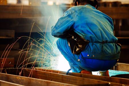 Workers at work, ongoing welding operation.の写真素材