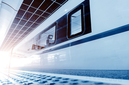 High-speed train stops at the station unmanned, blue tone image.のeditorial素材