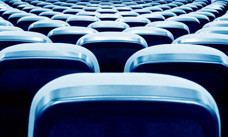 Neatly arranged cinema (theater) seating, blue tones.