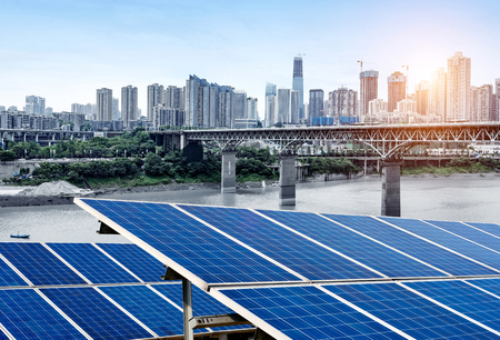 In front of the PV panel in the city landscape, Chongqing's light rail viaduct and high-rise.の写真素材