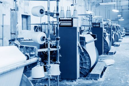 weaving machine produce white cloth.Blue tone map.の写真素材