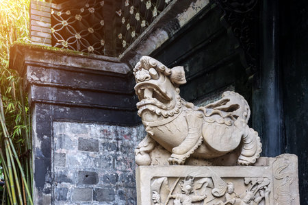 Chinese rock statue in an oriental garden in Chengdu, China.