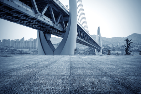 A city skyline a modern bridge in front of a marble floor.の写真素材