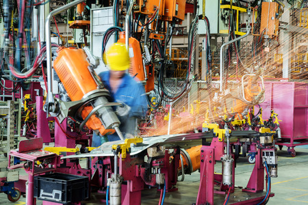 Car production line, skilled workers are working tense.の写真素材