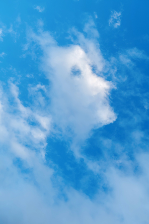 Blue sky, a strange cloud of clouds appears by chance, similar to the side of the human head.の写真素材