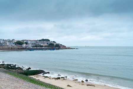 Dongshan Island coastline and town buildings, Fujian, Chinaの写真素材