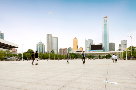 GUANGZHOU, CHINA - NOVEMBER 1, 2015: people on square in Zhujiang New Town of Guangzhou city in fall rainy day. Guangzhou is the third most-populous city in China with population about 13,5 mlnのeditorial素材