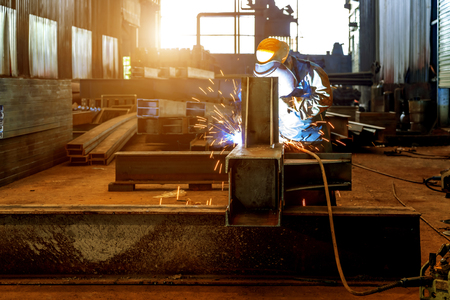 Workers at work, ongoing welding operation.の写真素材