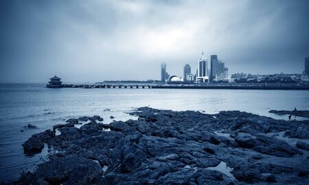 The trestle bridge by the sea, the Qingdao city landscape in the fog.の写真素材