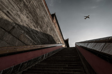 airplane flying over the ancient building