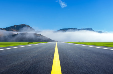 In the early morning, the road crosses the foggy mountains, Inner Mongolia, China.