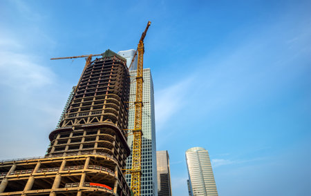 Building construction site, tall skyscrapers and cranes.