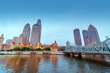 illuminated city waterfront downtown skyline with Haihe river,Tianjin,China.の写真素材