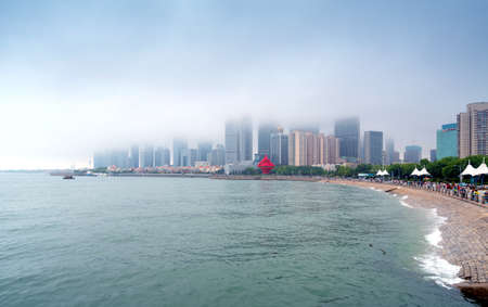 QINGDAO, CHINA - June 14, 2019: "May Wind" Sculpture at May Fourth Square in central business district of Qingdao with Chinese skyscrapersのeditorial素材
