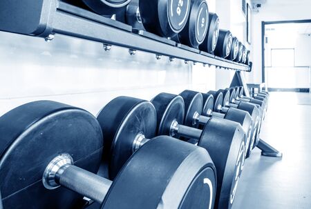 Rows of dumbbells in the gym with hign contrast and monochrome color toneの写真素材