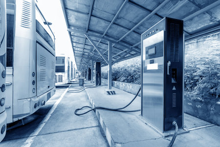 Charging station of an electric car in the background of a bus