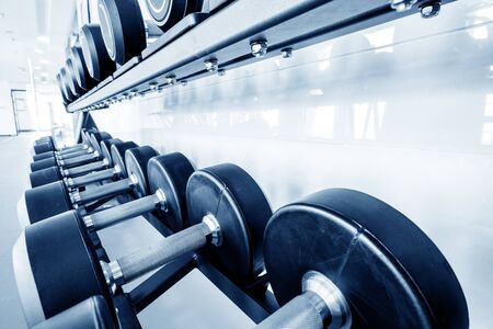 Rows of dumbbells in the gym with hign contrast and monochrome color toneの写真素材