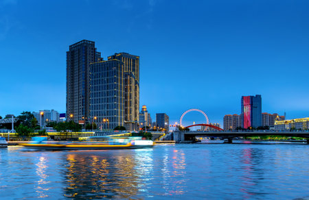 Illuminated city waterfront downtown skyline with Haihe river,Tianjin,China.の写真素材