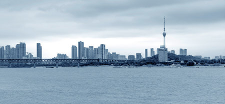 Wuhan Yangtze River Bridge and high-rise buildings on the banks of the Yangtze River, Hubei, China.の写真素材