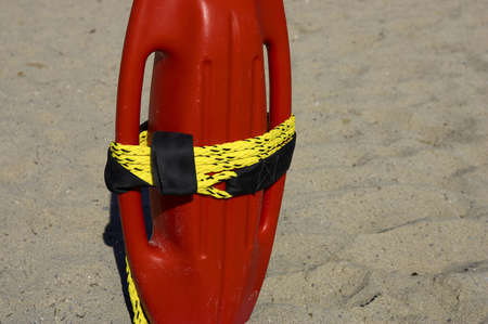 Red plastic buoyancy aid in the sand, cala bona beach, mallorca, majorca, spainの写真素材