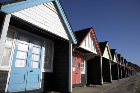 wooden beach huts in the spring along west cliff bournemouth dorset england uk taken in february...