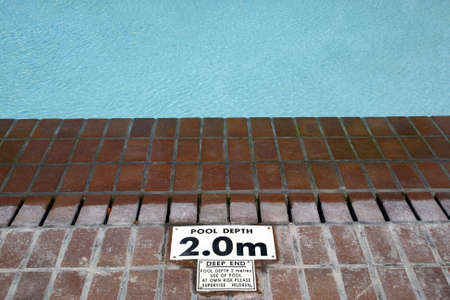 pool depth sign at the edge of the swimming pool knysna western cape province south africaの写真素材