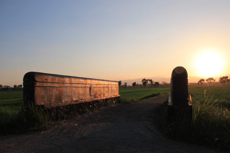 view of a village exit with a concrete bridge when the afternoon sun is about to setの写真素材