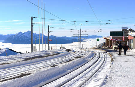 railway or tramway track in winter with the sea of clouds background, Rigi Kulm, Switzerlandの写真素材