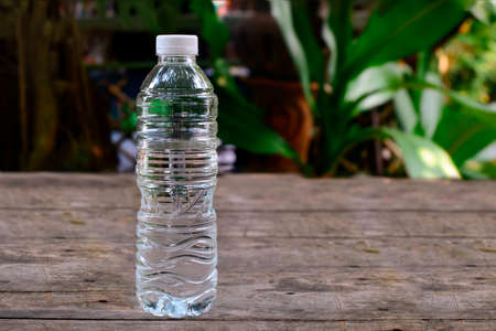 Water bottle on old wood background in the gardenの写真素材