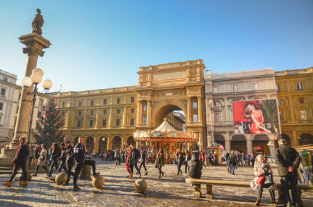 FLORENCE - DECEMBER 17, 2015. People sightseeing before christmas around Piazza della Repubblica in Florence, Italy.のeditorial素材