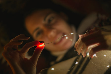 Close up female squeezing decorative light concept photo. Fingernails. Side view photography with...