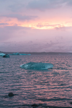 Floating iceberg landscape photo. Beautiful nature scenery photography with snowy mountains, sunset...