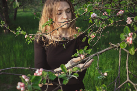 Enjoying cherry blossoms in spring scenic photography. Picture of beautiful woman with natural...