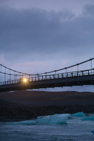 Bridge over frozen sea gulf landscape photo. Beautiful nature scenery photography sunset sky with on...