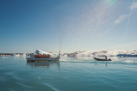 Ship with people sailing across sea landscape photo. Beautiful nature scenery photography with iceberg on background. Idyllic scene. High quality picture for wallpaper, travel blog, magazine, articleの写真素材