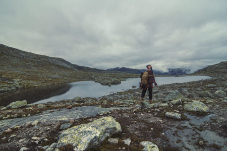 Woman with backpack waking at highland landscape photo. Beautiful nature scenery photography with...