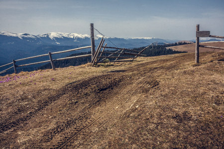 Log fence at hill pastureland landscape photo. Beautiful nature scenery photography with mountains...