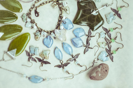 Close up collection of craft bijouterie with gemstone concept photo. Top view photography with light display on background. High quality picture for wallpaper, travel blog, magazine, articleの写真素材