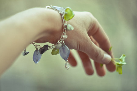 Close up stylish bracelet on female wrist concept photo. Craft jewelry. First view hand photography with blurry background. High quality picture for wallpaper, travel blog, magazine, articleの写真素材