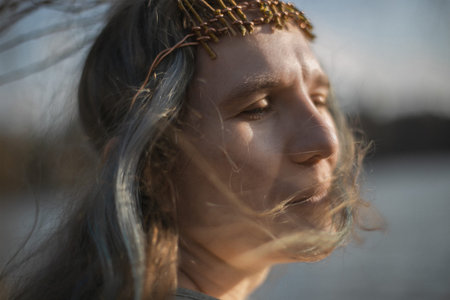 Close up dreaming adult woman with fluttering gray hair portrait picture. Closeup side view...