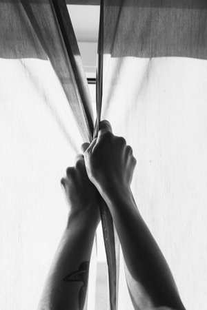 Close up hands closing curtains monochrome concept photo. Privacy. First-person view photography...