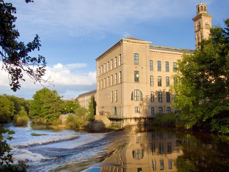 Salts mill viewed from across the River Aire in the early evening.の写真素材
