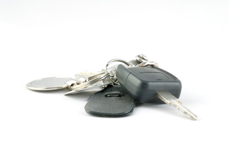 Car keys on a key fob set against a white background.の写真素材
